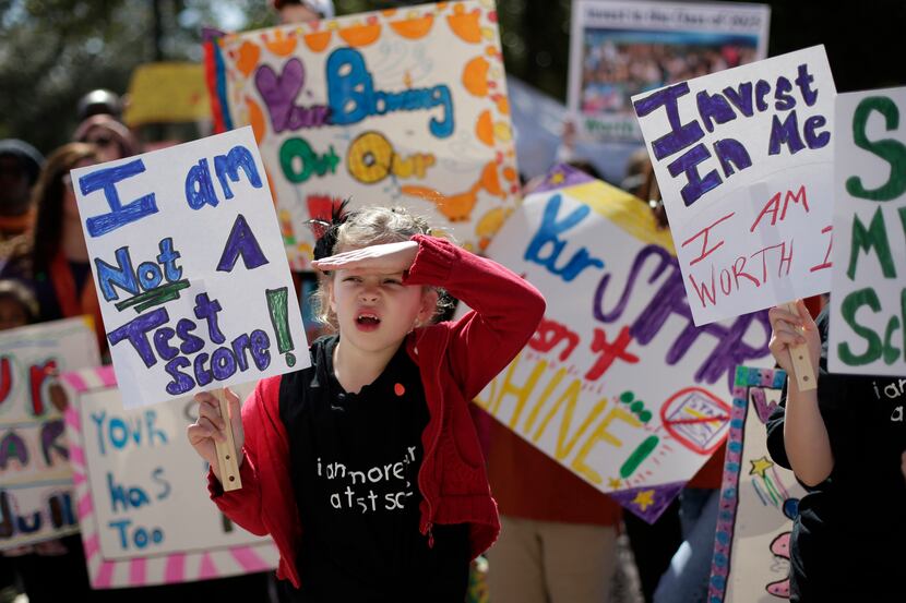 Cate Foughty, 6, of Frisco, Texas, takes part in a rally for Texas public schools at the...