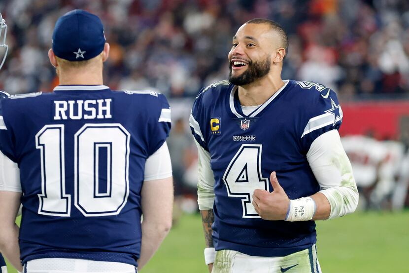 Dallas Cowboys quarterback Dak Prescott (4) laughs with fellow quarterback Cooper Rush (10)...