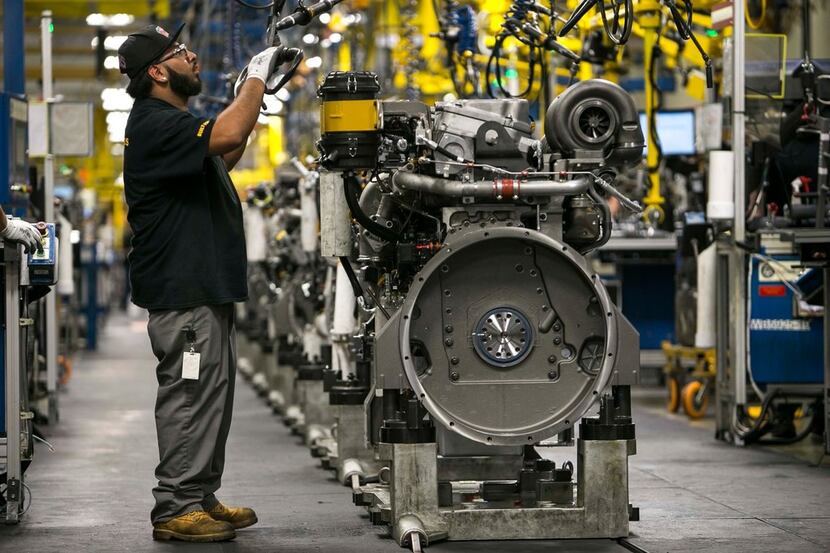 Mike Gomez assembles an engine at Caterpillar's engine manufacturing plant in Seguin, Texas....