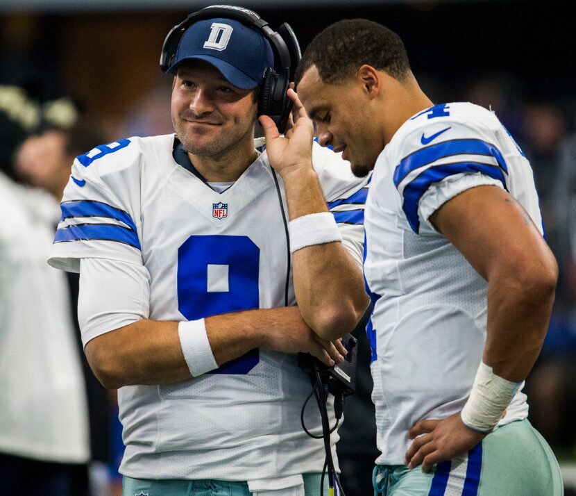 Dallas Cowboys quarterback Tony Romo (9) and quarterback Dak Prescott (4) talk on the...