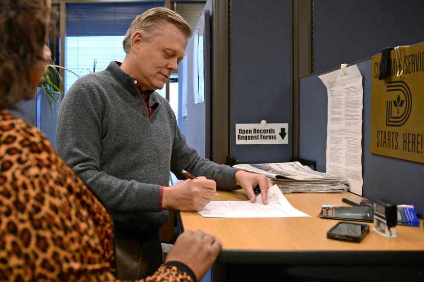 
Jim Moll fills out an open records request next to Open Records Manager Jeri Carter Lawson...
