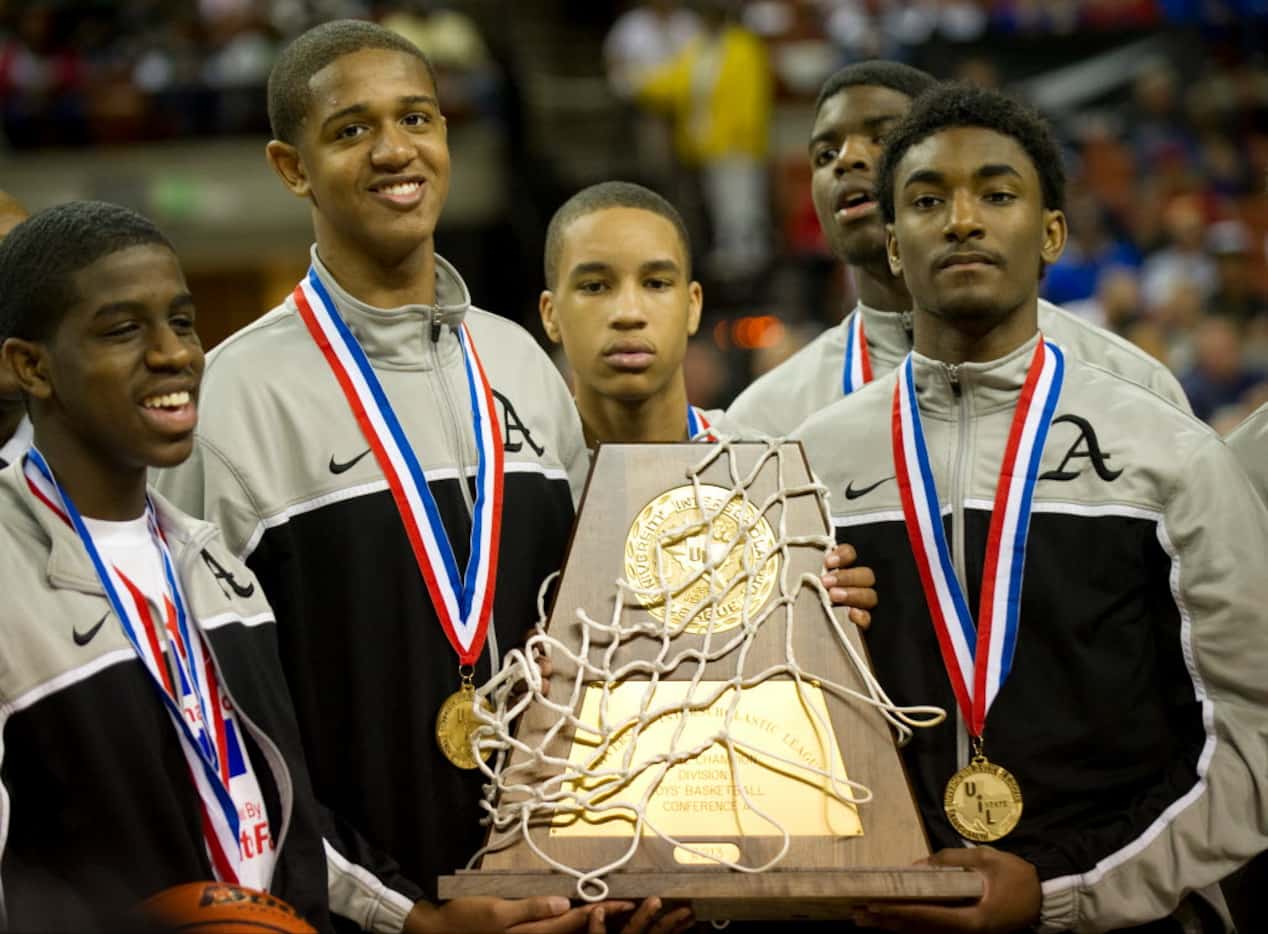 Dallas Triple A Academy players celebrated with their trophy after defeating Mumford in the...
