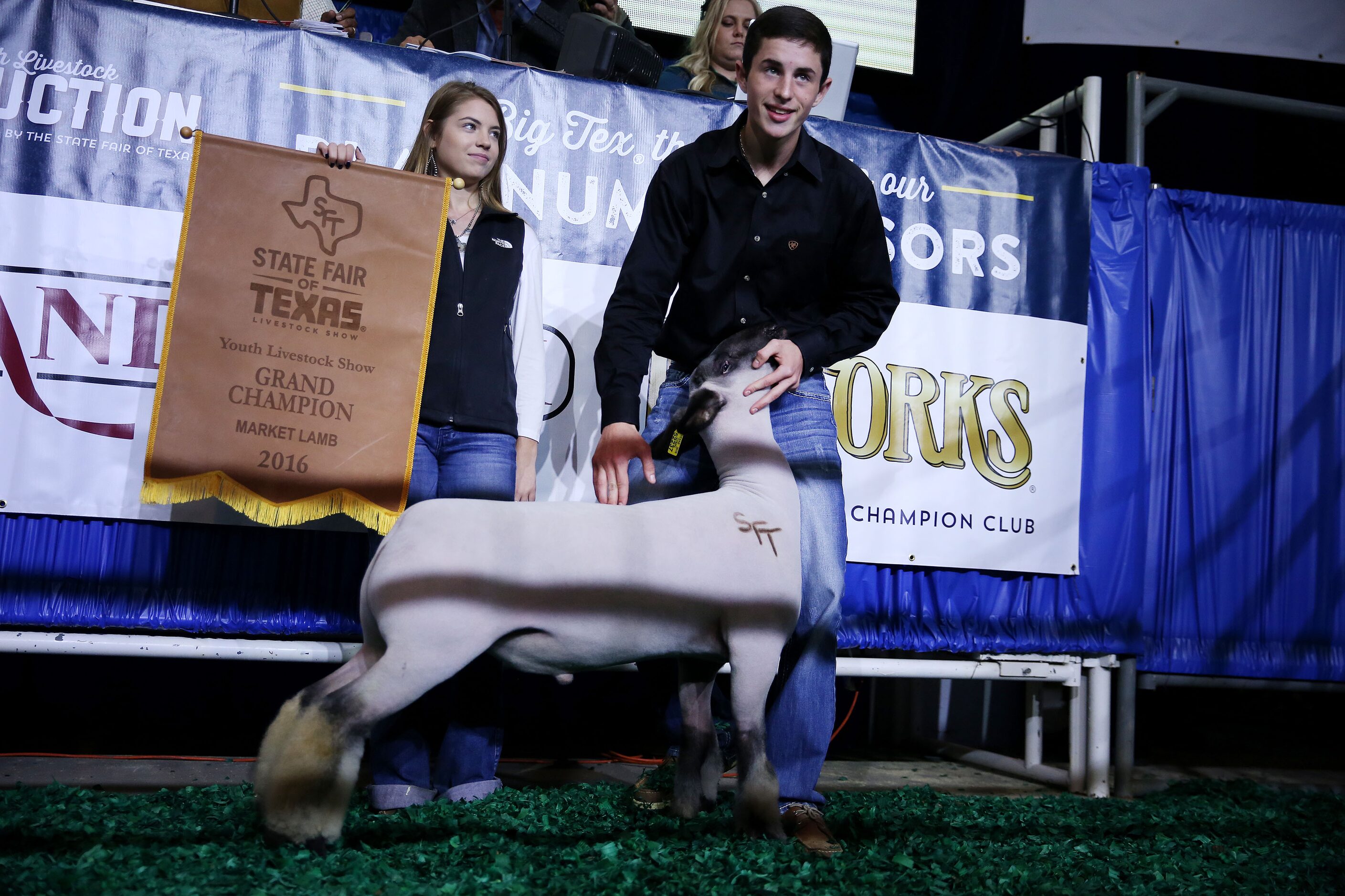 Kolton Neuse (right) stands with his grand champion lamb and friend, Morgan Hollingsworth...