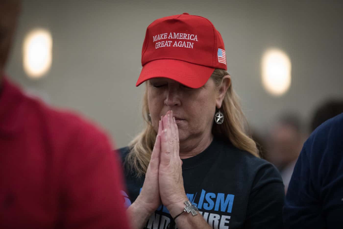 Trump supporter Sharon Alford participates in a group prayer at the start of a campaign...