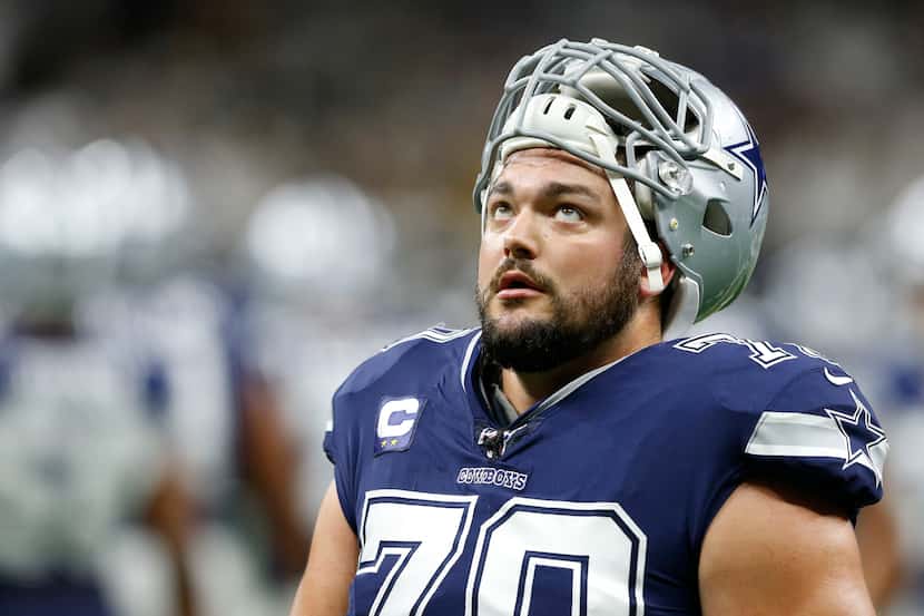FILE - Dallas Cowboys offensive guard Zack Martin (70) looks up as he exits the field after...