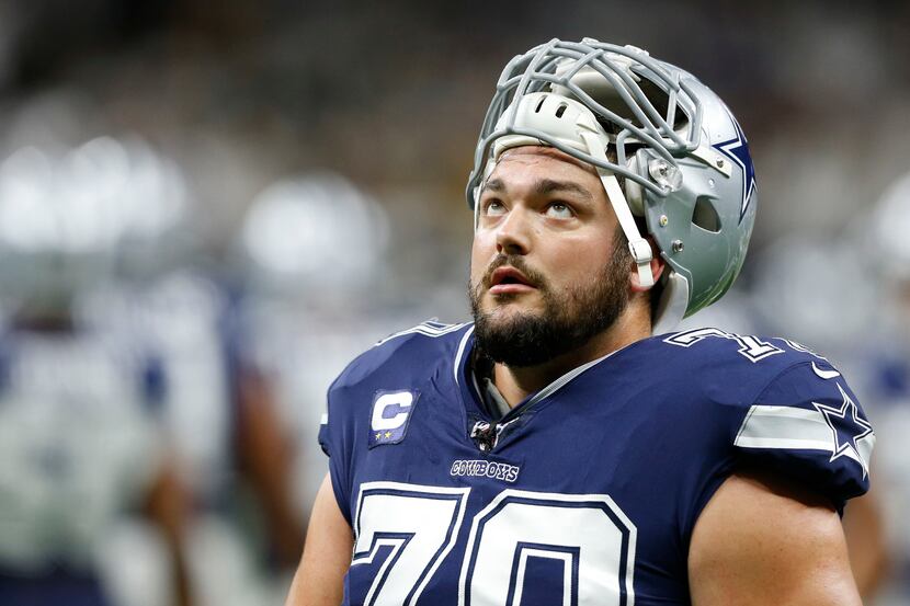 Dallas Cowboys offensive guard Zack Martin (70) looks up as he exits the field after warmups...
