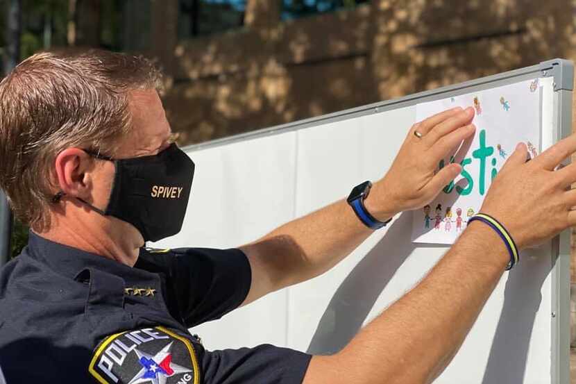 Irving Police Chief Jeff Spivey hangs art in support of George Floyd and the black community.