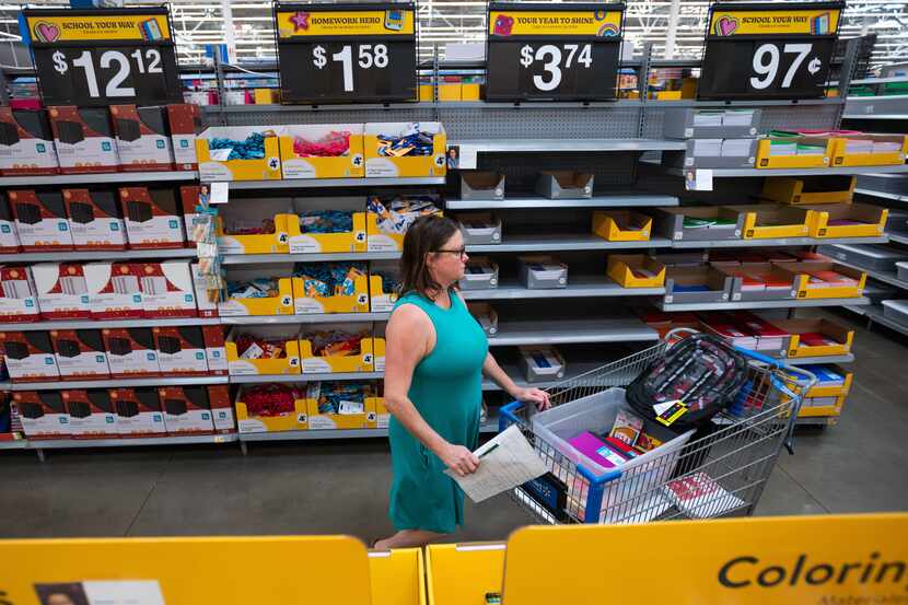 Heather Adcox, of Farmers Branch, browses a back to school aisle as she shops for her...
