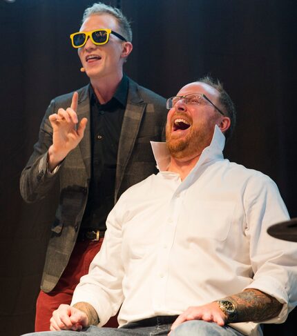 Magician Trigg Watson performs a trick with volunteer Brian Nichols.