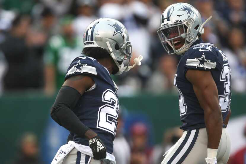 Dallas Cowboys cornerback Jourdan Lewis (27) and cornerback Byron Jones (31) celebrate after...