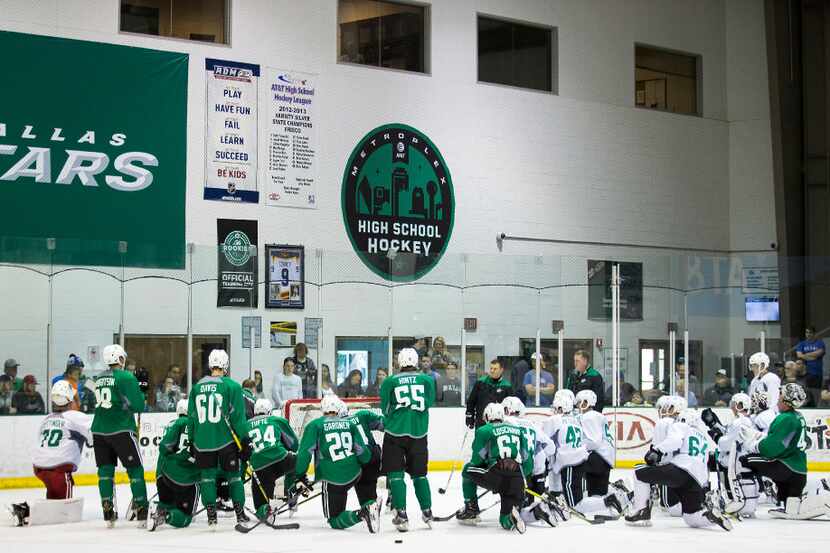 Players huddle on the ice on the first day of Dallas Stars development camp at the Dr Pepper...