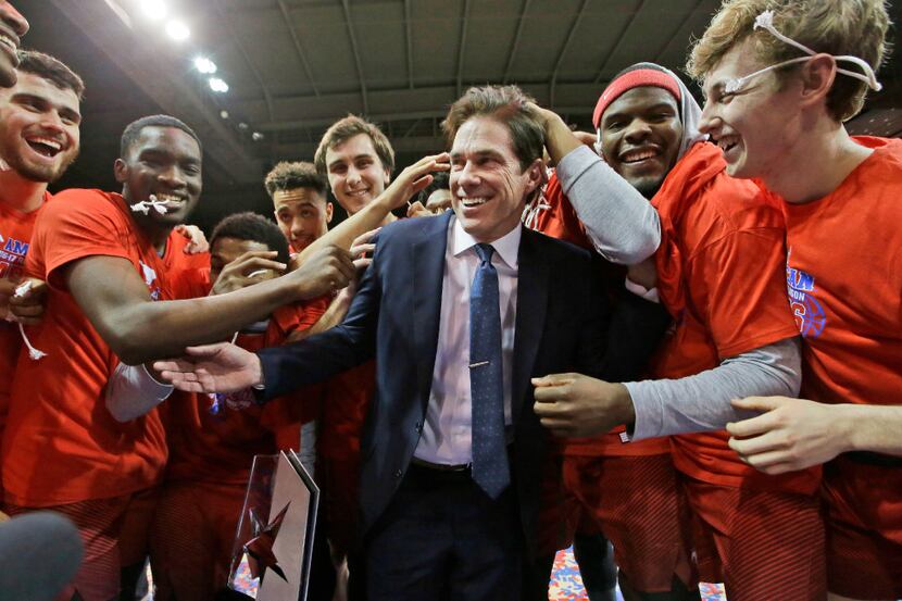 SMU head coach Tim Jankovich, center, celebrates winning the American Athletic conference...