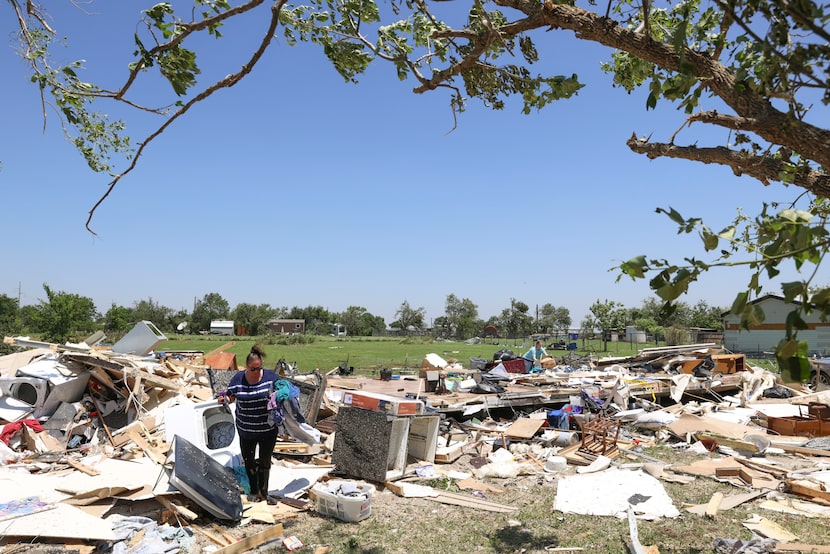 Amber Lidster, who has lived in Valley View for 40 of her 44 years,  salvages belongings...