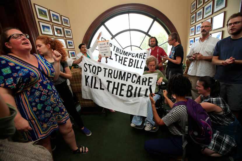 Protesters against the Republican health care bill gather inside the office of Sen. Rob...