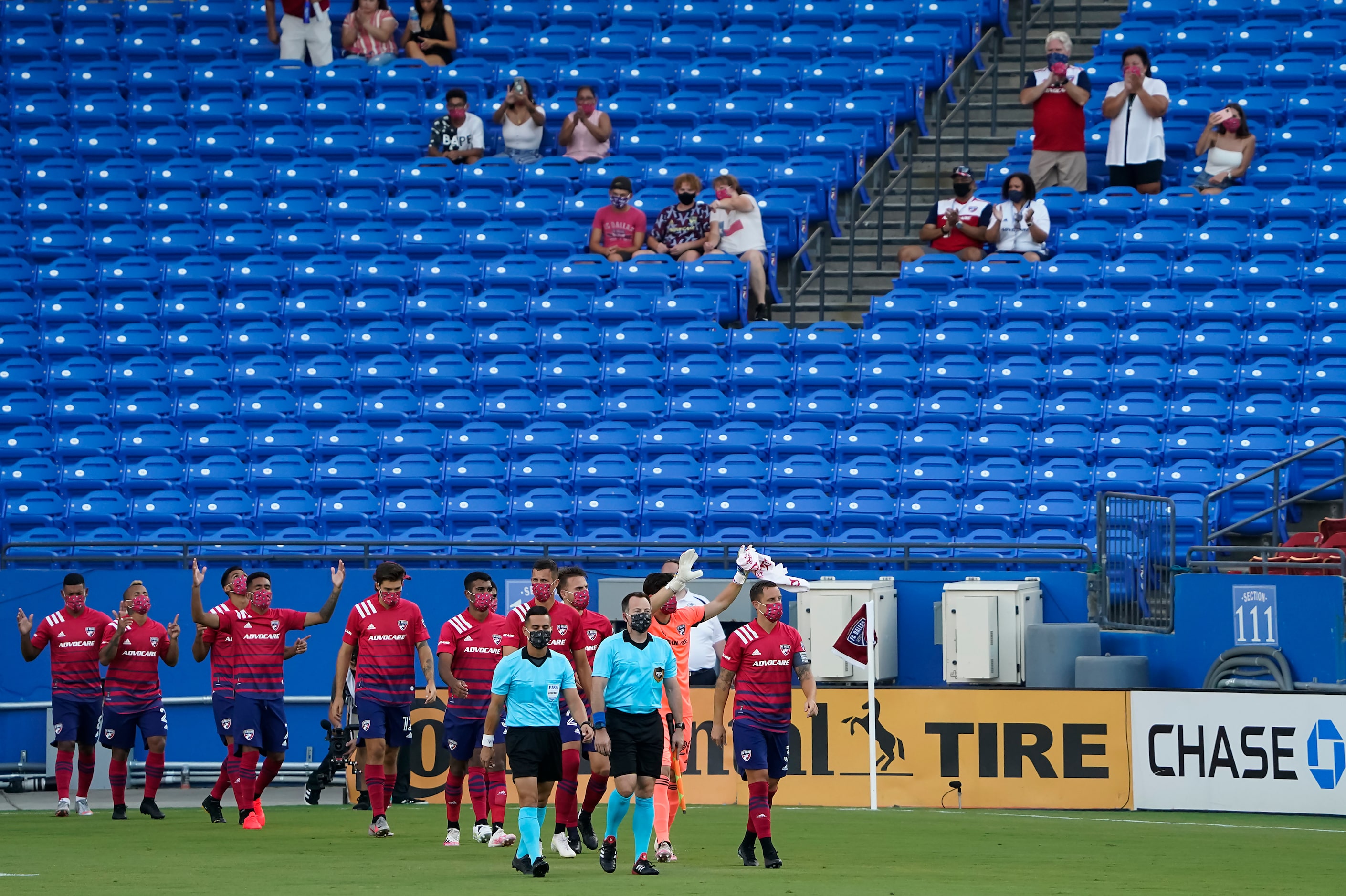 FC Dallas player acknowledge supporters as they take the field before an MLS soccer game...