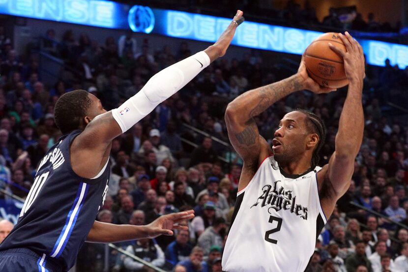 FILE - Mavericks forward Dorian Finney-Smith (10) defends Clippers forward Kawhi Leonard (2)...