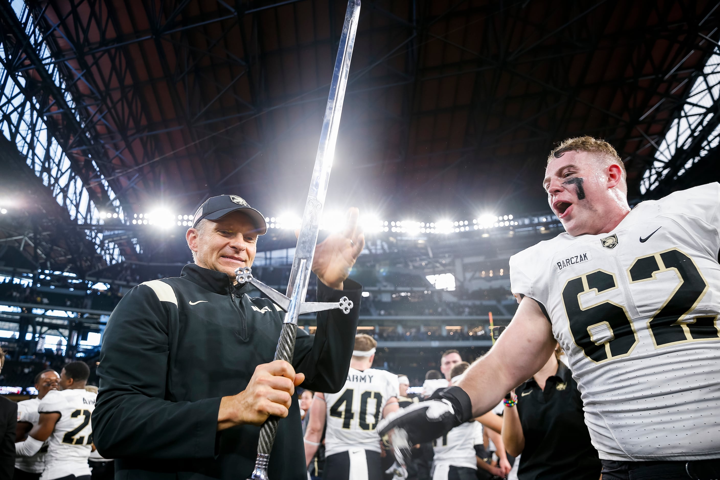 Army Black Knights head coach Jeff Monken is handed the sword by Army Black Knights...
