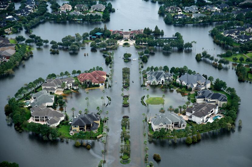 Flood waters rise Lakes on Eldridge North neighborhood near the Addicks Reservoir in  West...