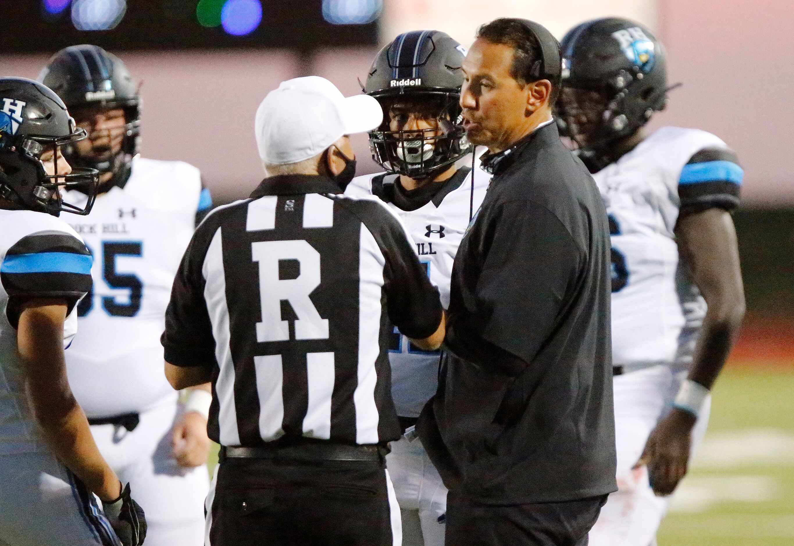 Rock Hill High School head coach Mark Humble talks to the ref during the first half as...