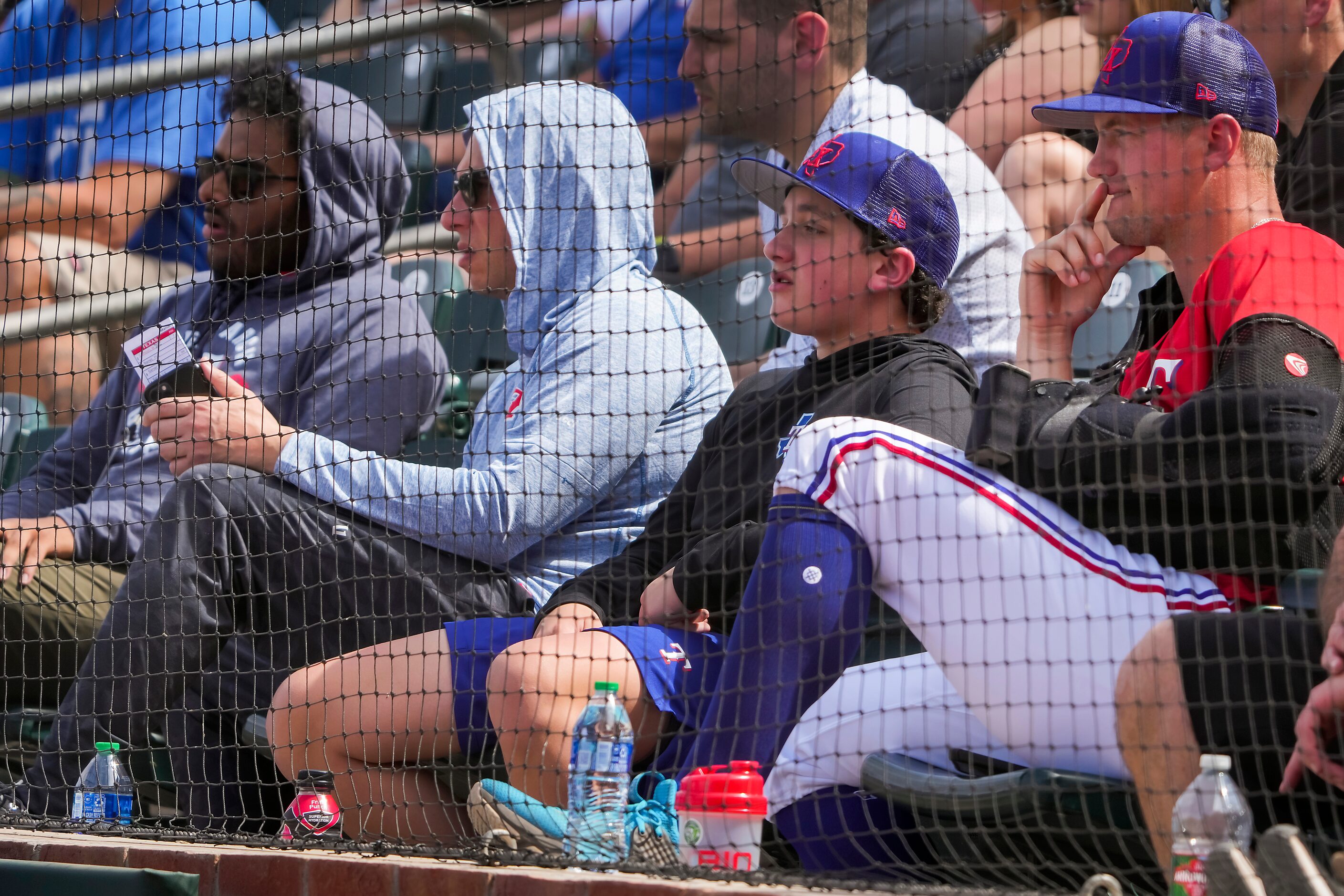 Texas Rangers infielder Josh Jung wears a sling as he watches from the stands during a...