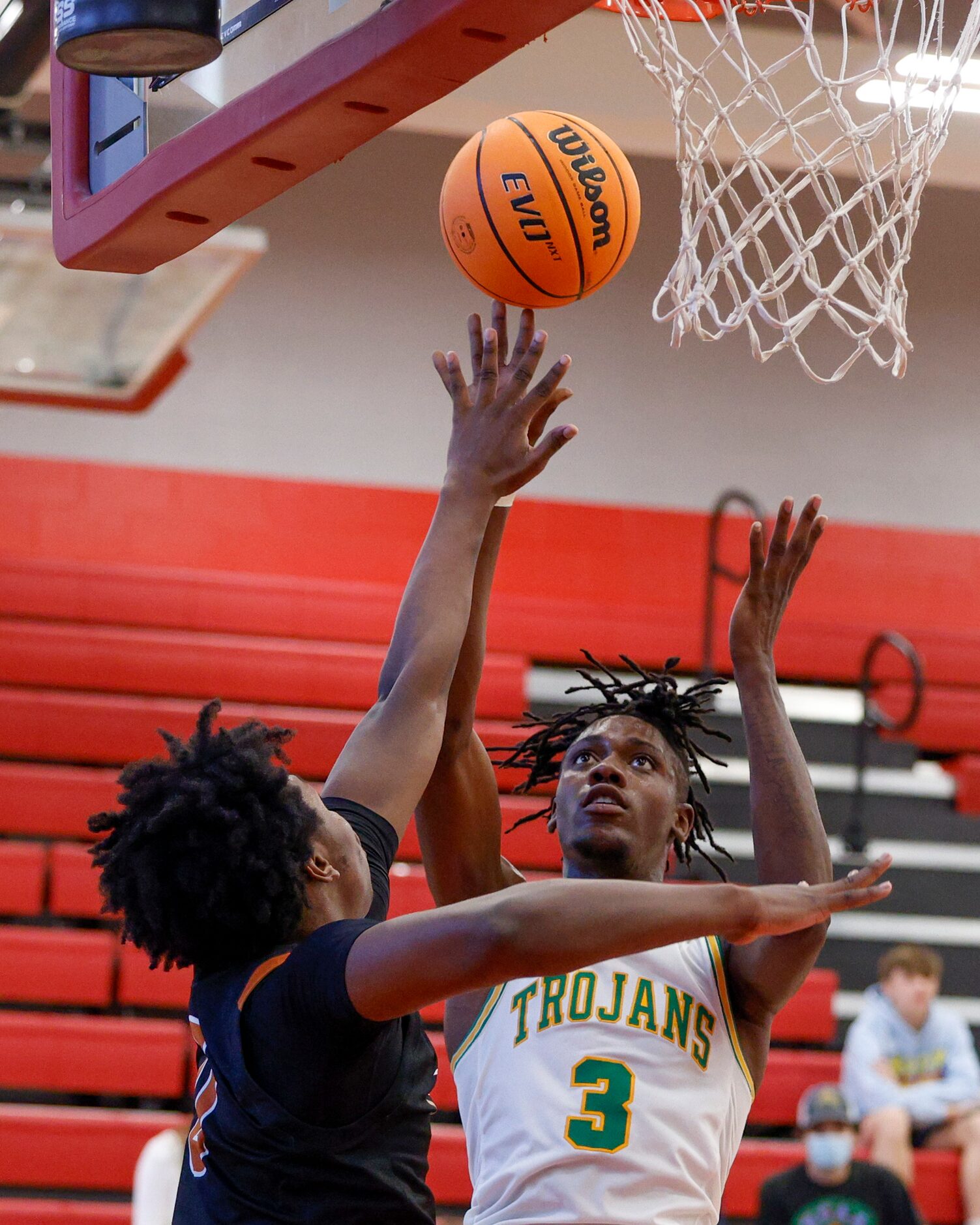 Madison forward Leonard Miles IV (3) shoots the ball over W.T. White forward Dre Cole (0)...