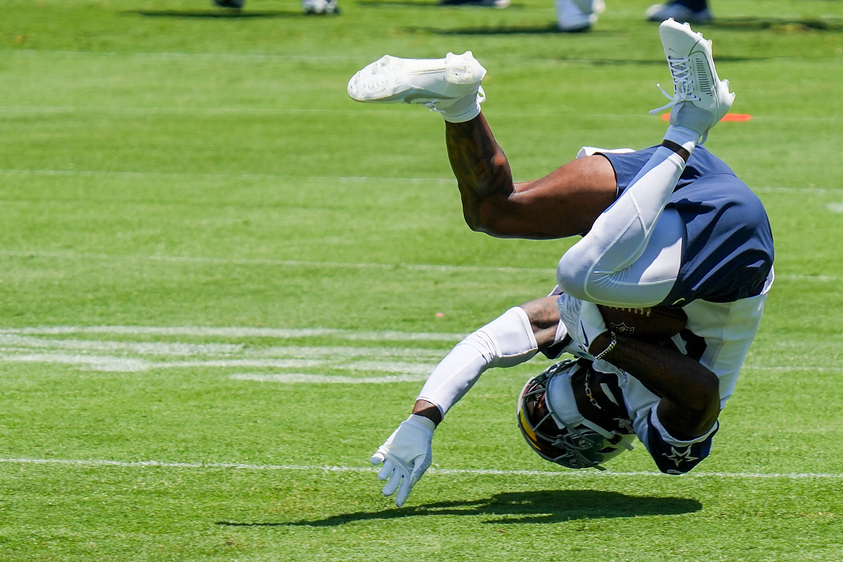 Dallas Cowboys wide receiver CeeDee Lamb (88) tumbles after making a one-handed catch during...