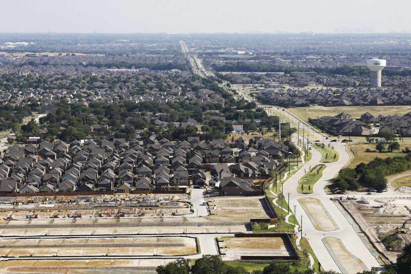Established neighborhoods, new homes and homes under construction are seen in McKinney in...