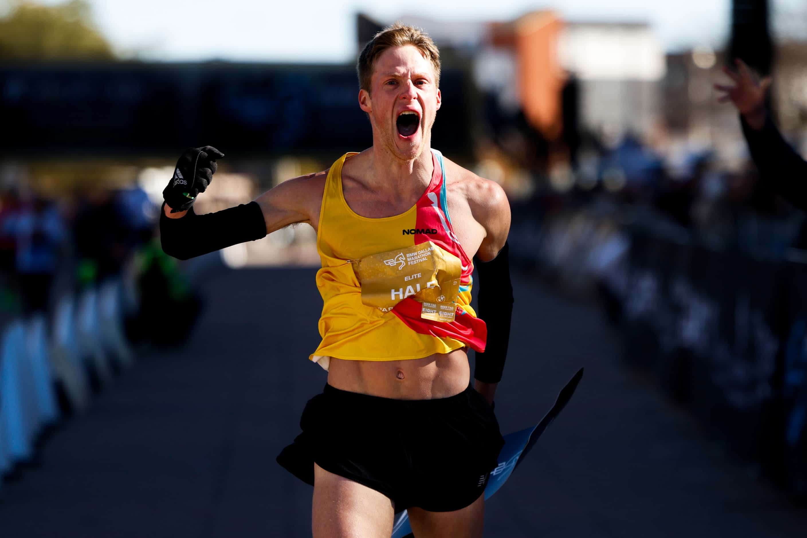 Men’s marathon finisher Joseph Hale, 30, of Grapevine, celebrates after reaching the finish...