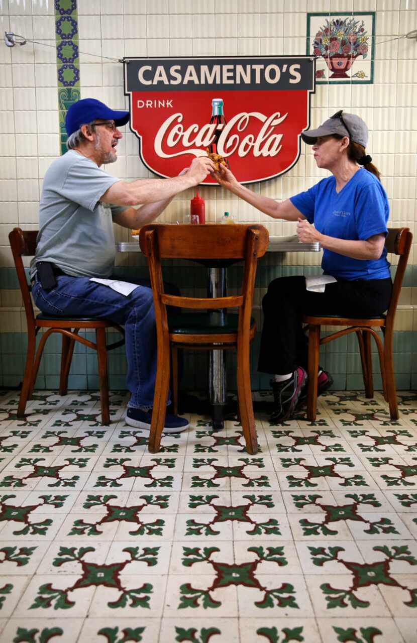 Deborah Bilsky hands her husband, Steve Bilsky, a bite of her sandwich while eating lunch in...