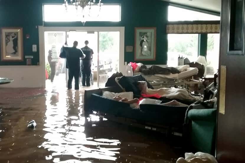 Residents lie on sofas while waiting to be evacuated from the Cypress Glen senior care...
