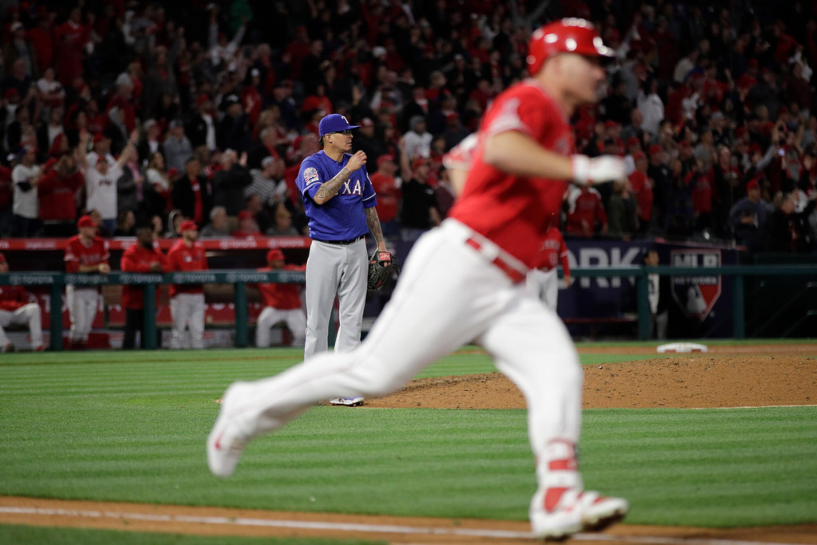 Texas Rangers relief pitcher Jesse Chavez stands at the edge of the mound as Los Angeles...