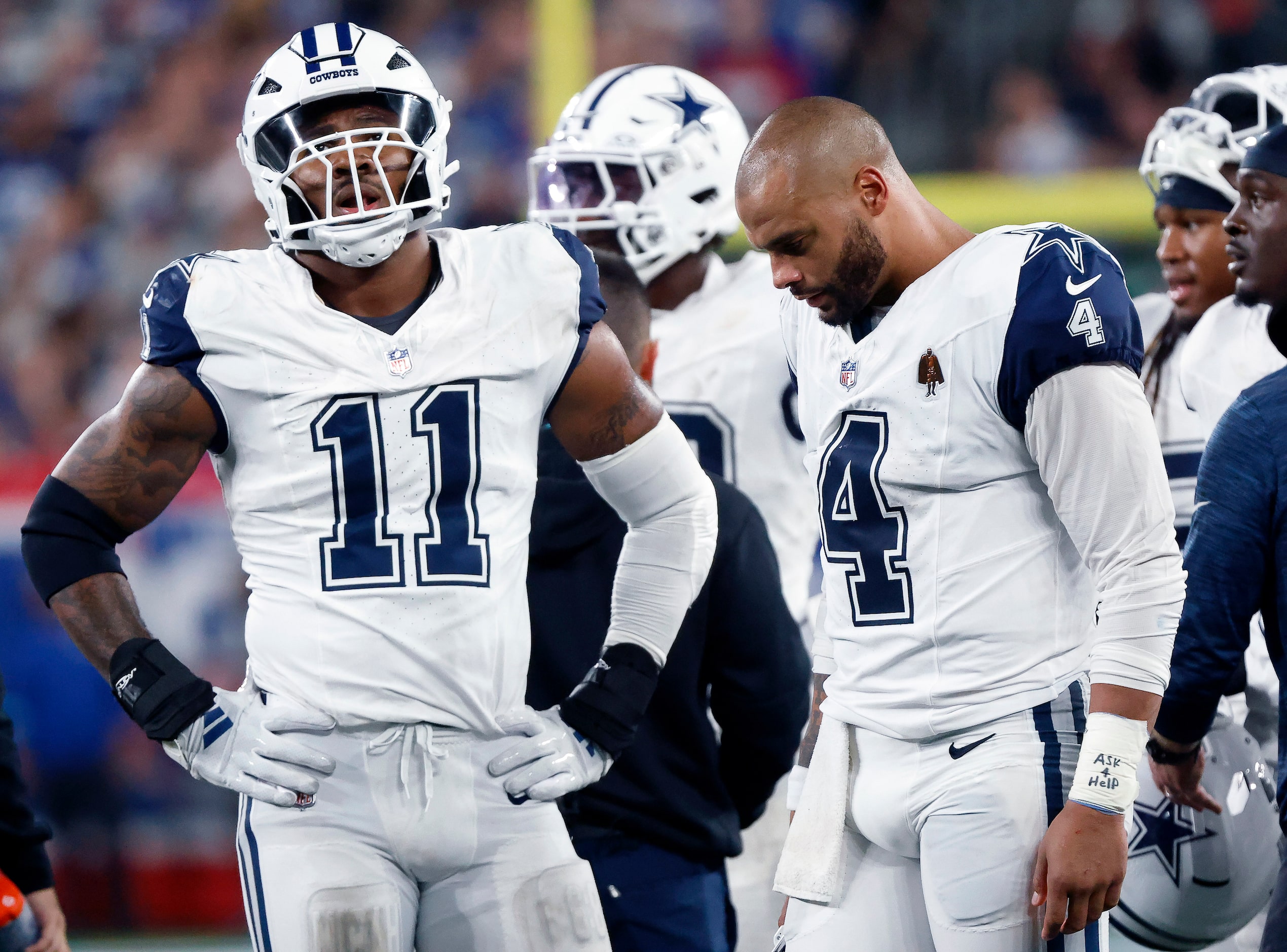 Dallas Cowboys linebacker Micah Parsons (11) and quarterback Dak Prescott (4) wait for a...