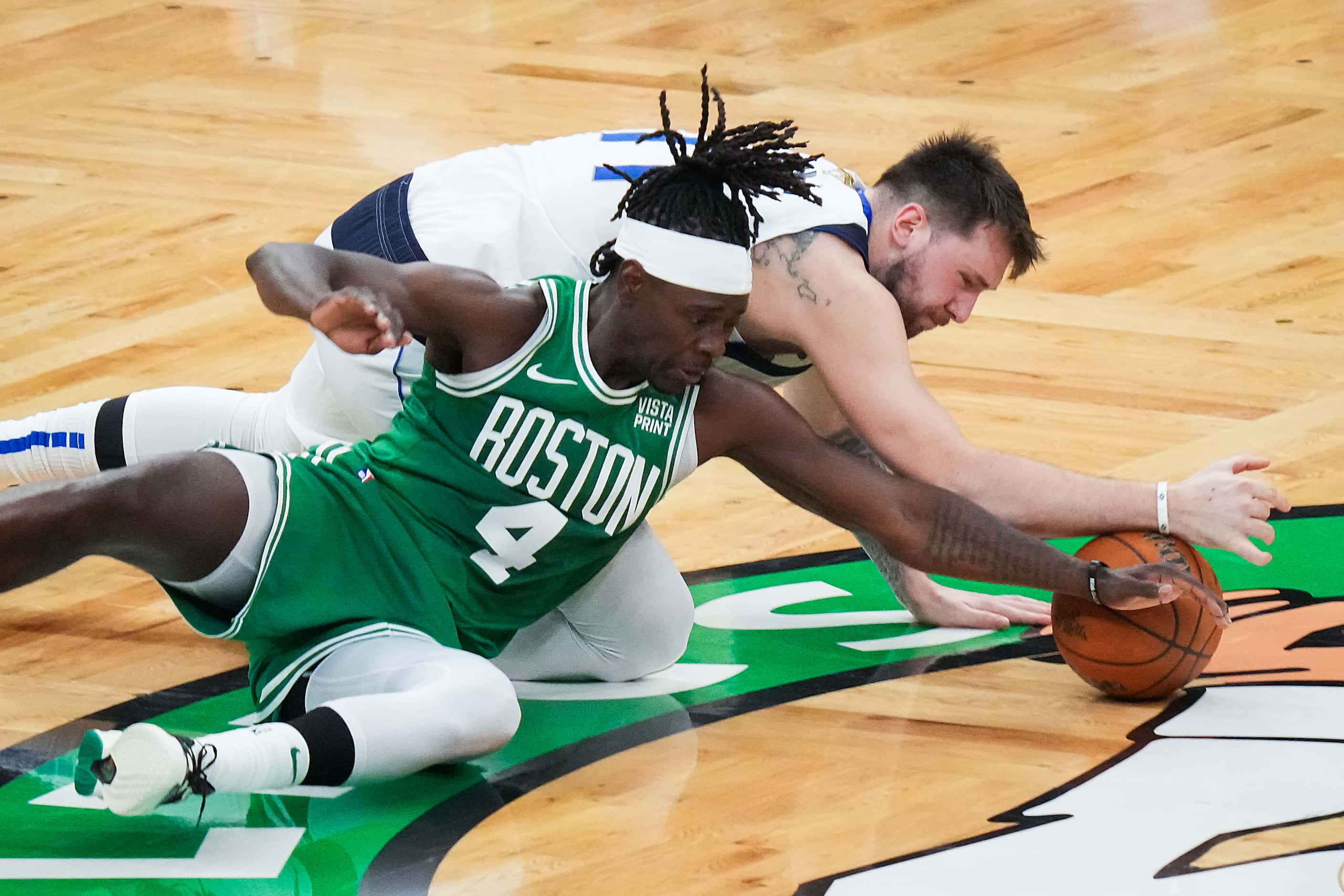 Dallas Mavericks guard Luka Doncic (77) turns the ball over against Boston Celtics guard...