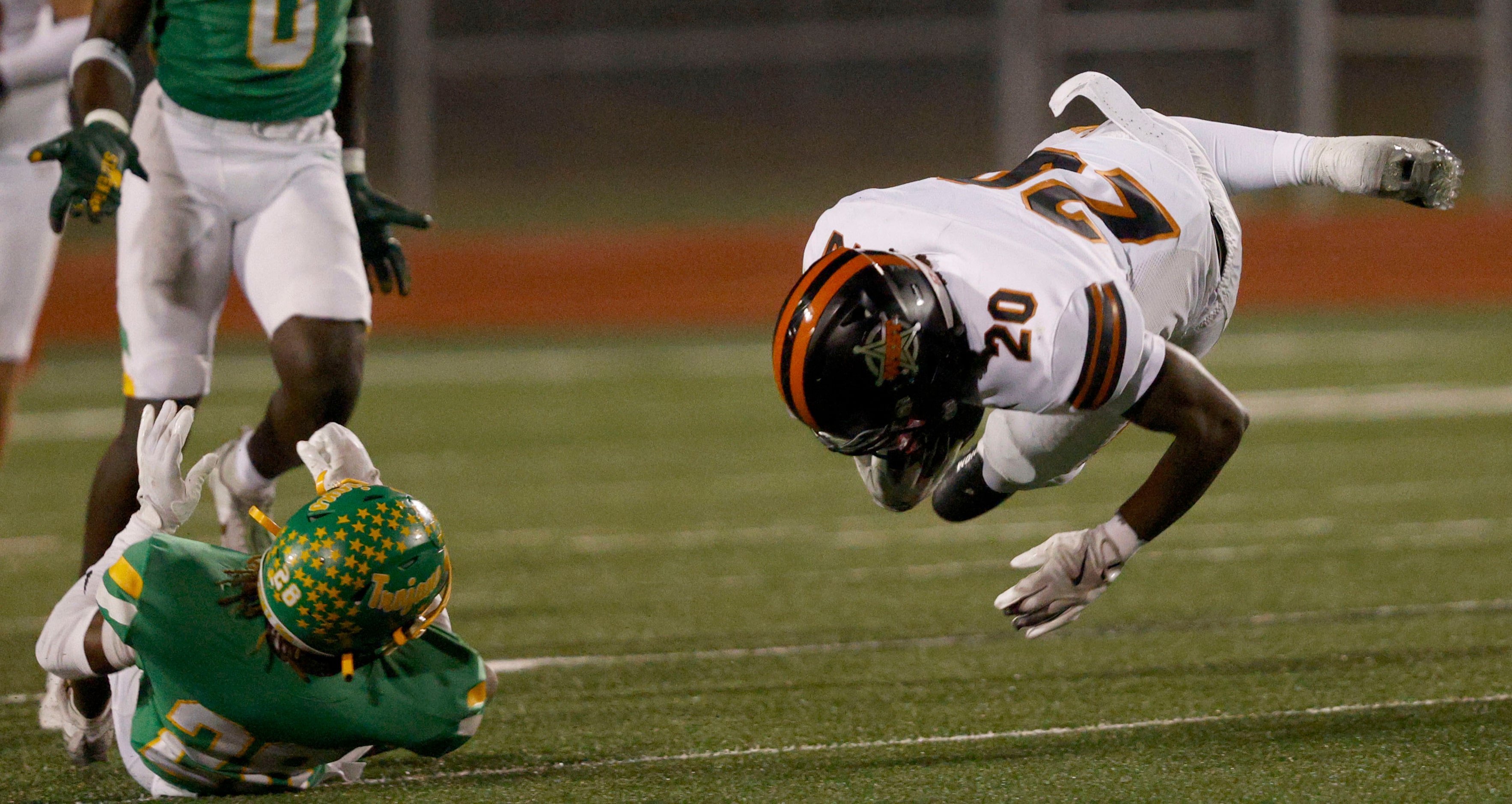 West Mesquite's Kamari Carter (20) fells on the field after he was tackled by Newman Smith's...