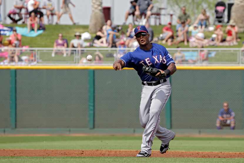 Texas Rangers third baseman Adrian Beltre throws out a runner in a spring exhibition...