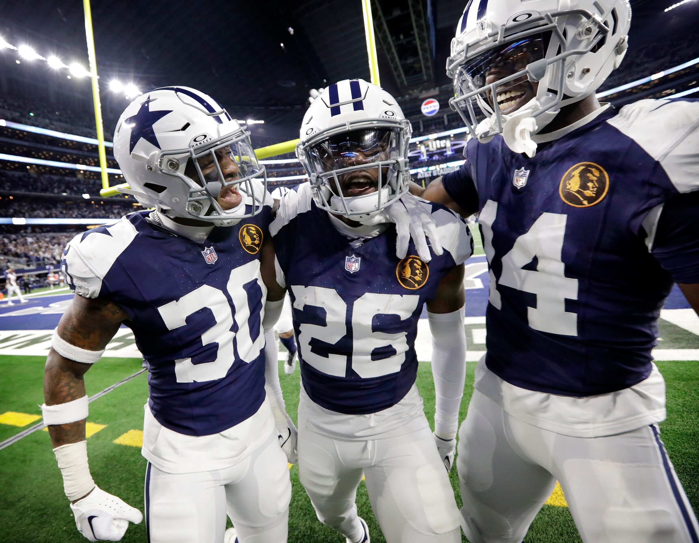 Dallas Cowboys cornerback DaRon Bland (26) is congratulated by teammates Juanyeh Thomas (30)...