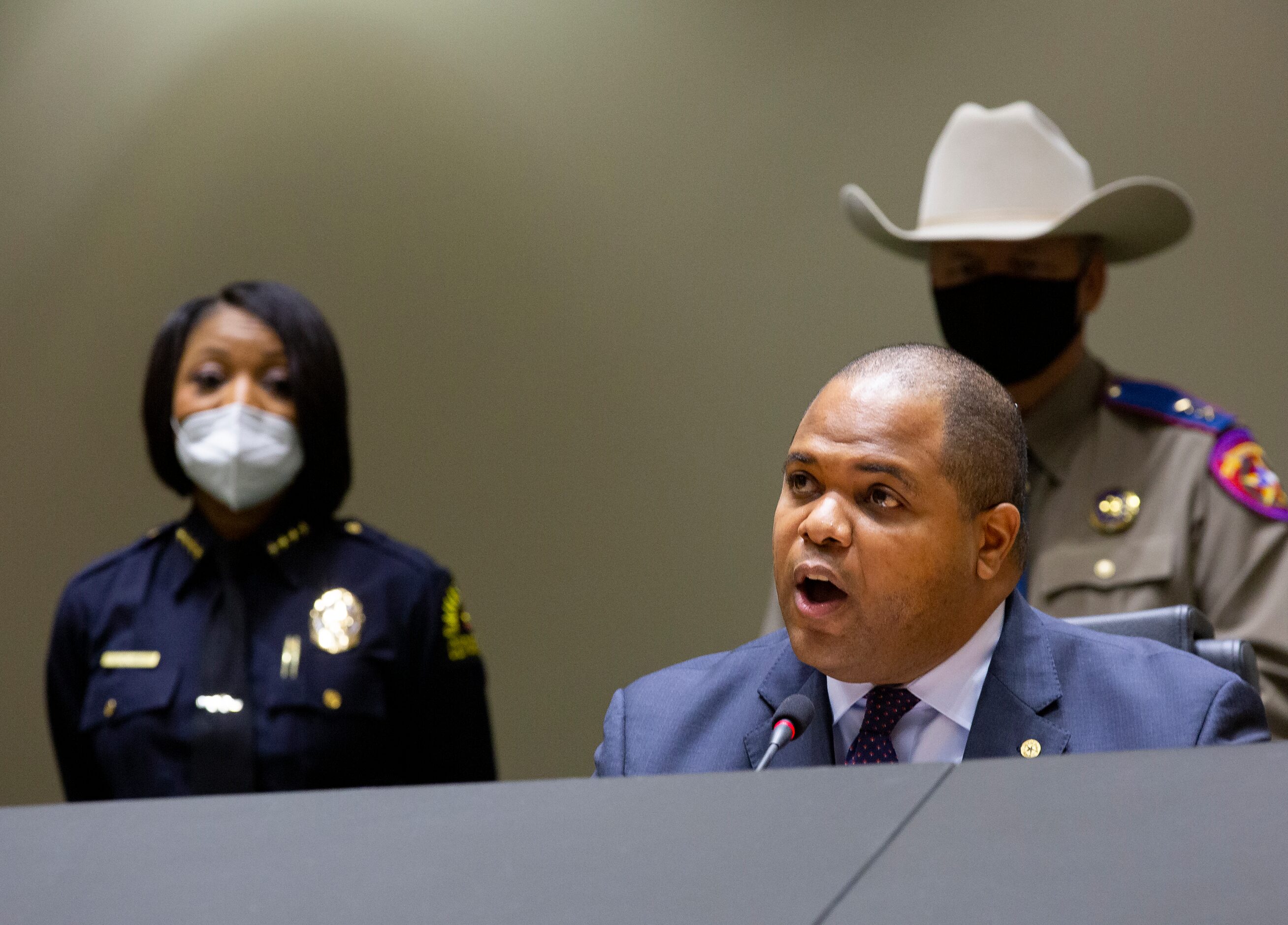 Dallas Police Chief Reneé Hall (left) listens as Dallas Mayor Eric Johnson speaks at a press...