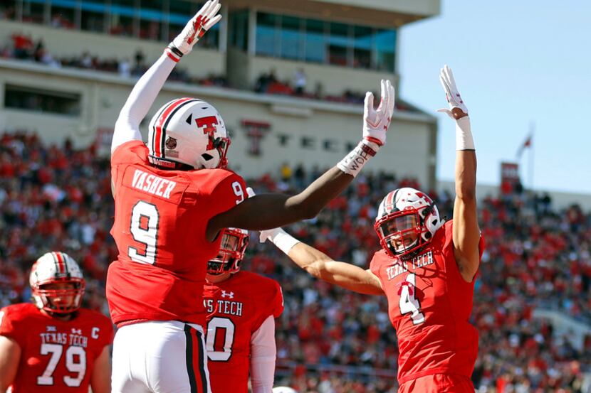 Texas Tech's T.J. Vasher (9) celebrates with Antoine Wesley (4) after scoring a touchdown...