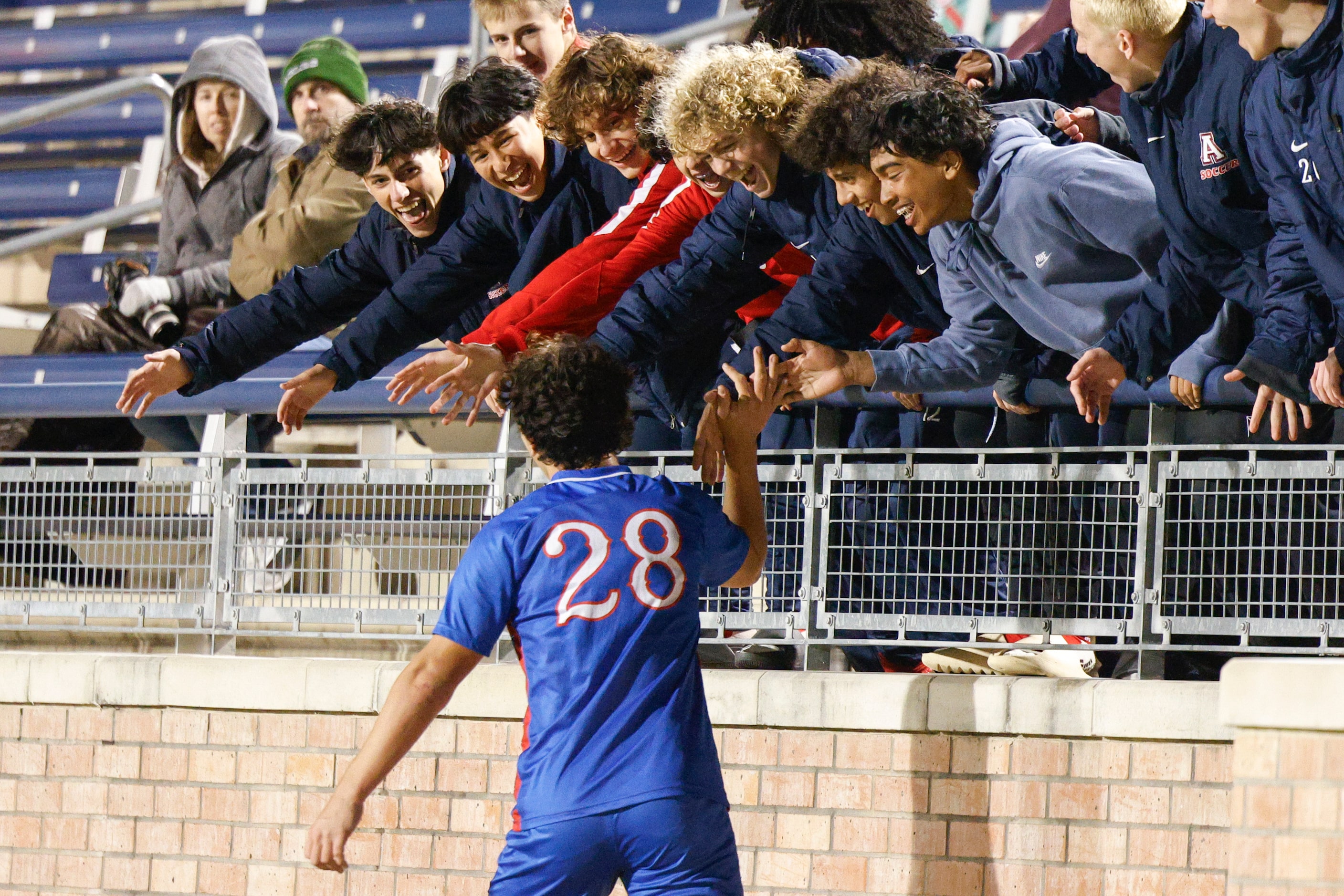 Allen’s Evan Ruiz (28) high fives teammates during the second half of a District 5-6A boys...