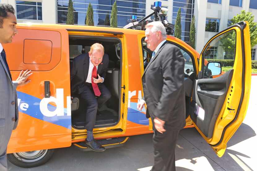 Frisco Mayor Jeff Cheney is greeted by DCTA's Carter Wilson as he emerges from the back seat...