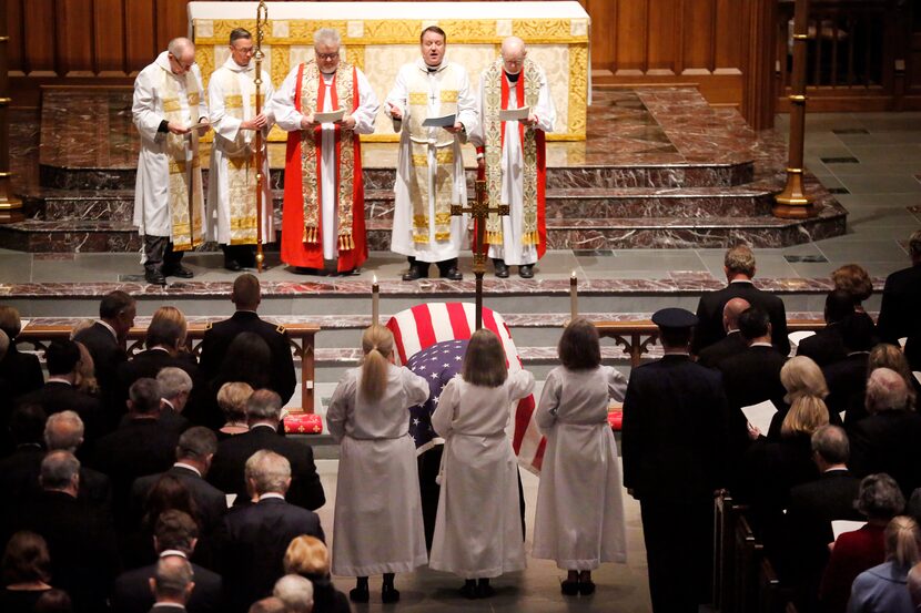 Reverend Russell J. Levenson, Jr (second from right) leads the clergy before the funeral...