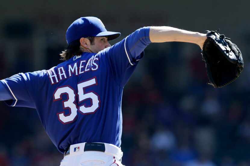 Texas Rangers starting pitcher Cole Hamels throws during the first inning of a baseball game...