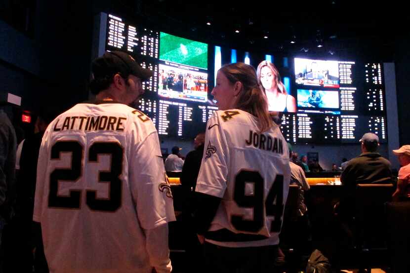 Football fans wait for kickoff in the sports betting lounge at the Ocean Casino Resort in...
