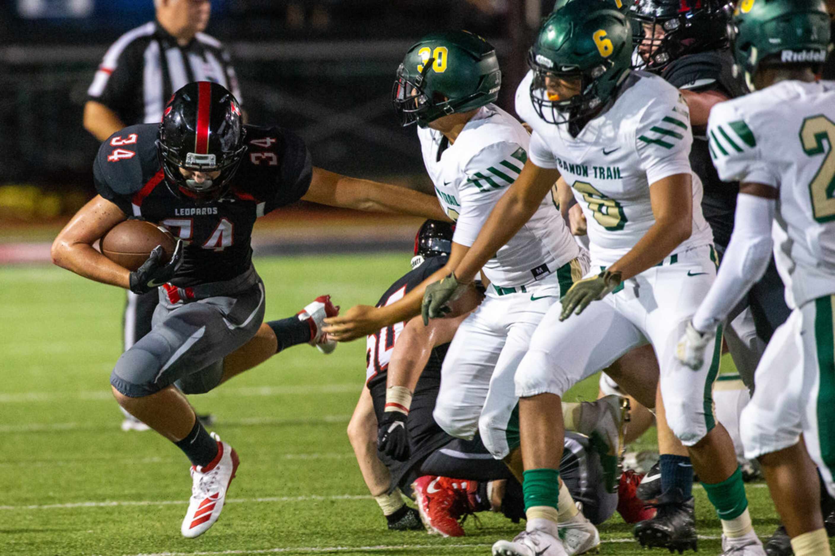 Lovejoy running back Koen Nunn keeps defense away during the football game between Lebanon...