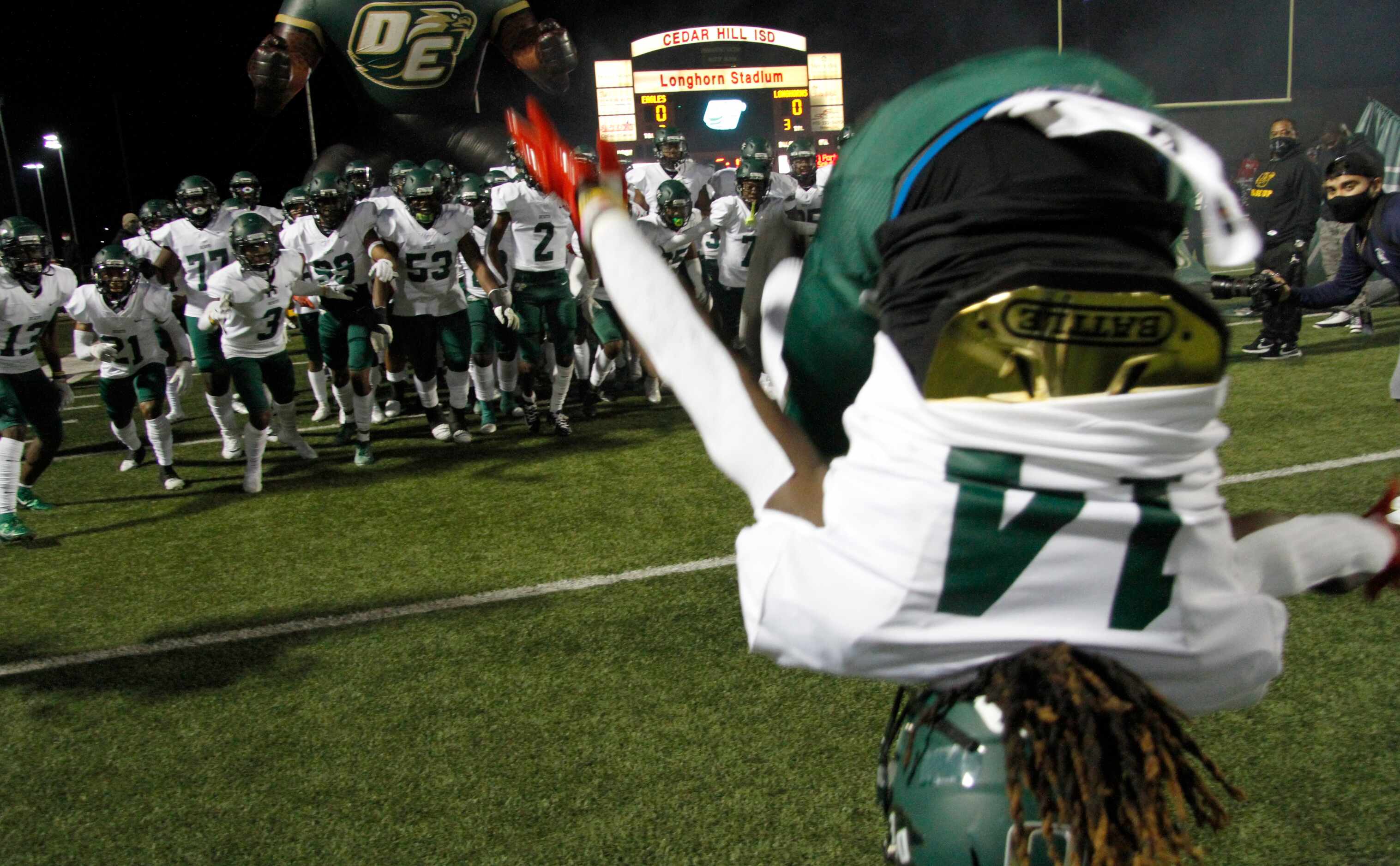 DeSoto's Darius Bailey (14) leads fellow Eagles onto the field with a flip prior to the coin...