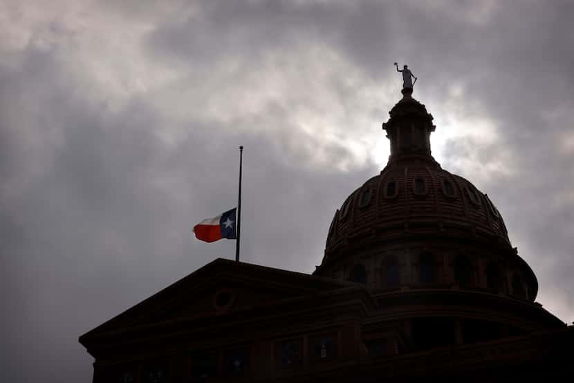 The state flag and Goddess of Liberty sit atop the Texas State Capitol in Austin, Texas,...