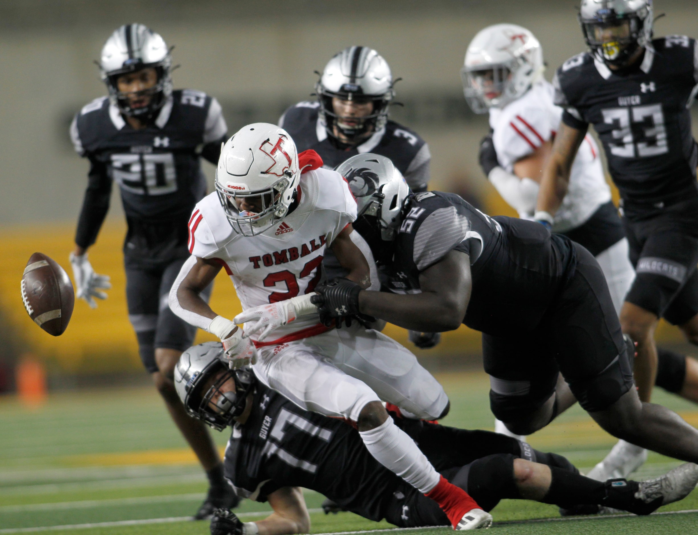 Denton Guyer linebacker Brooks Etheridge (17), left, and defensive lineman Pelumi Olanipekun...