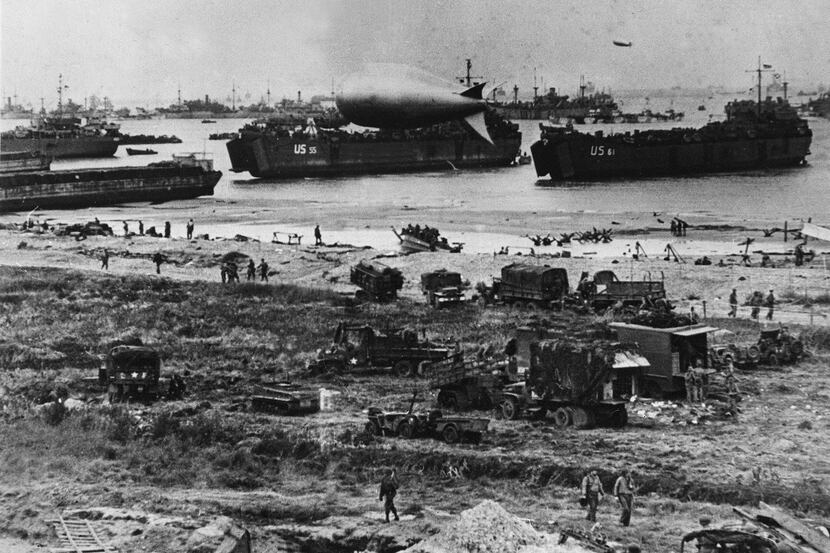 U.S. troops disembark from landing crafts during D-Day on June 6, 1944 after Allied forces...