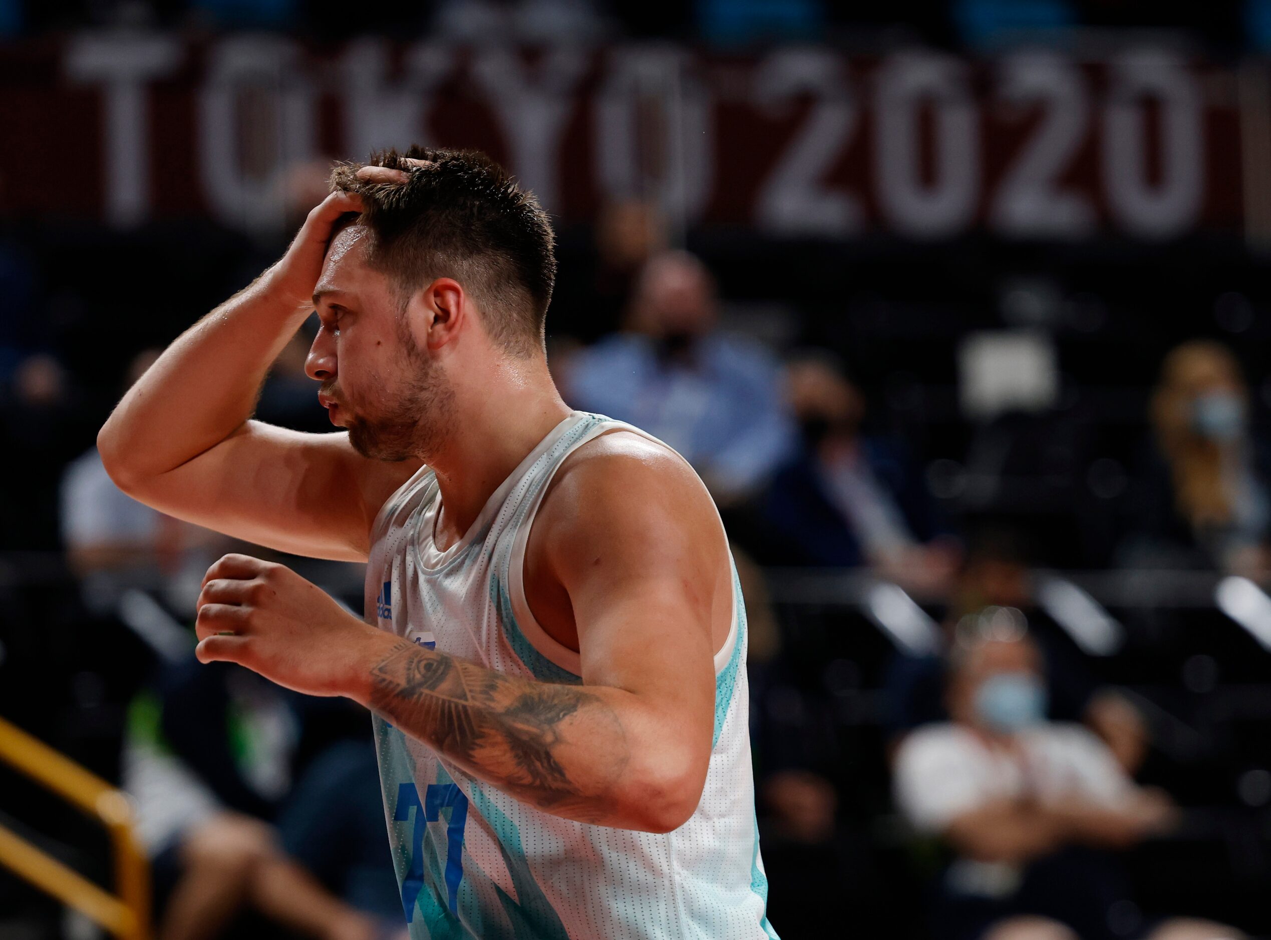 Slovenia’s Luka Doncic (77) questions a call in a basketball game against Japan during the...