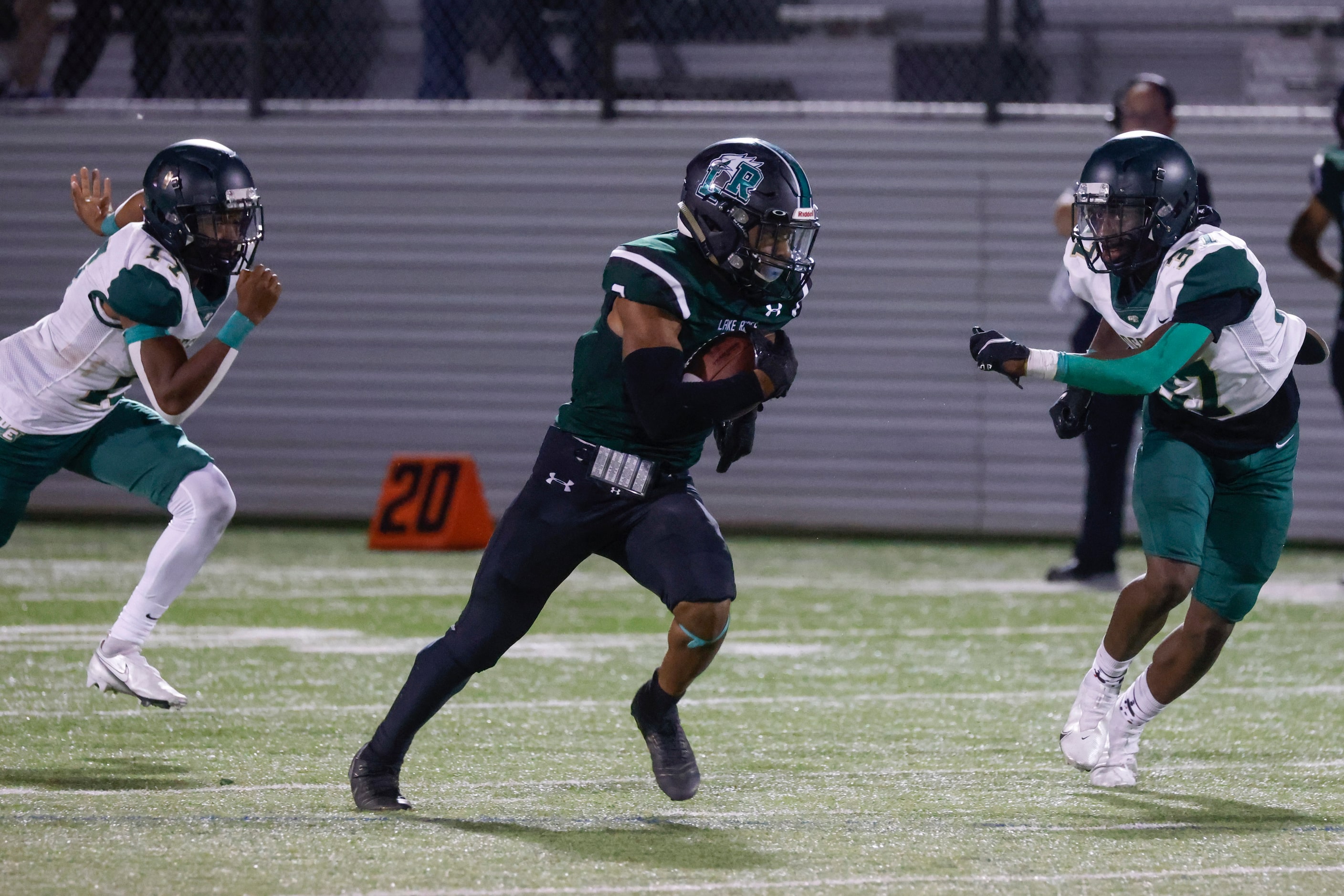 Lake Ridge High’s Tanner Grimes (2), center, runs past DeSoto High’s Je’Shan McCoy (17),...